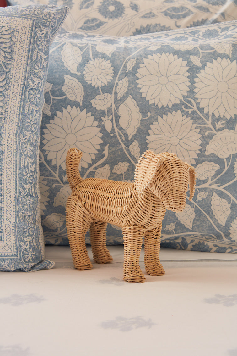 Little Potcake by Amanda Lindroth is a natural rattan weave dog figure. Lifestyle image