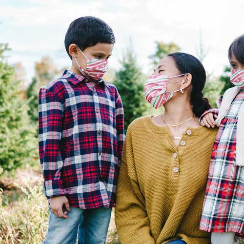 Holiday Paws Kid's Face Mask disposable with paw prints on red ribbon mother and son
