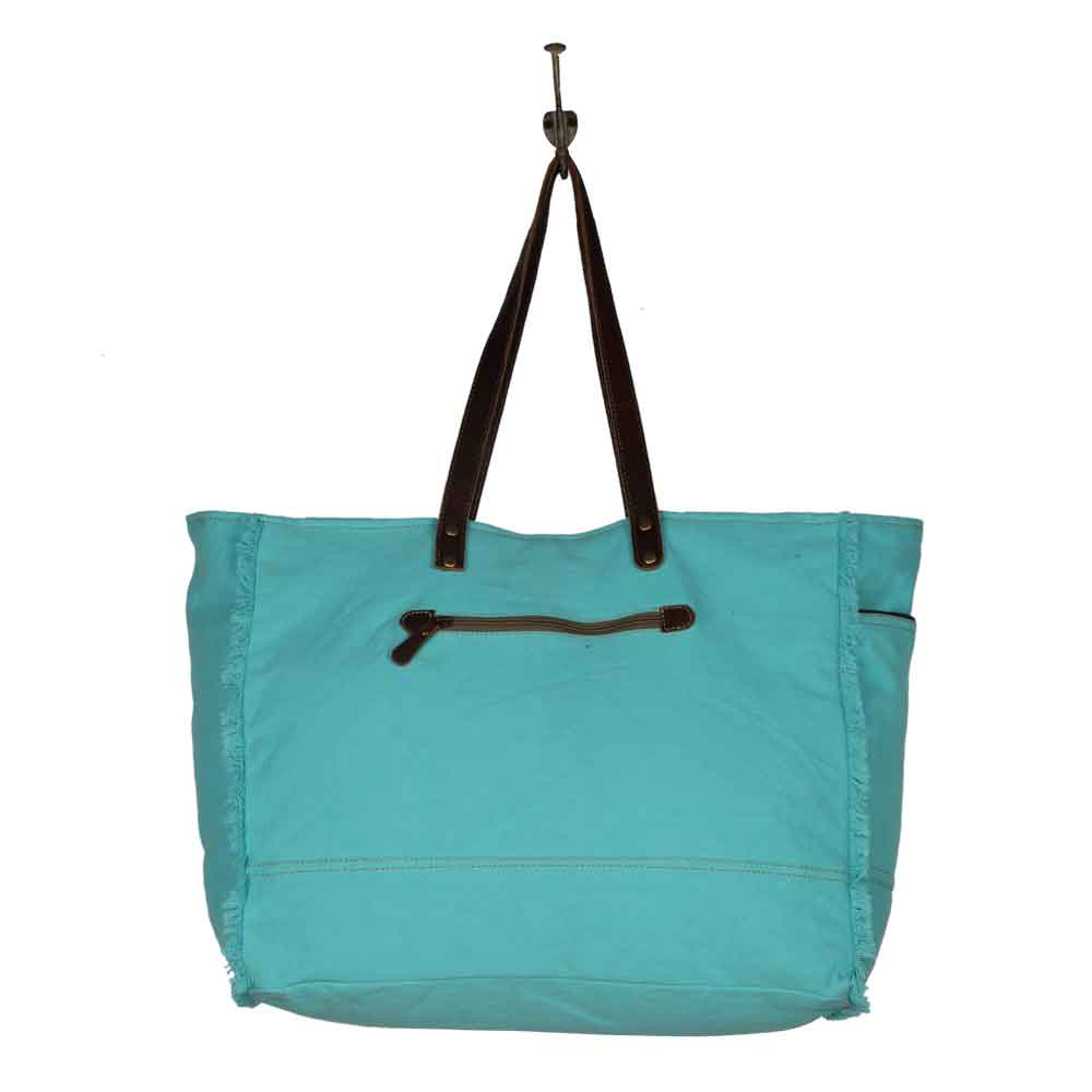 Vivacious Weekender Bag Hanging on Hook Back View Image Myra Bag Harley Butler Trading Company