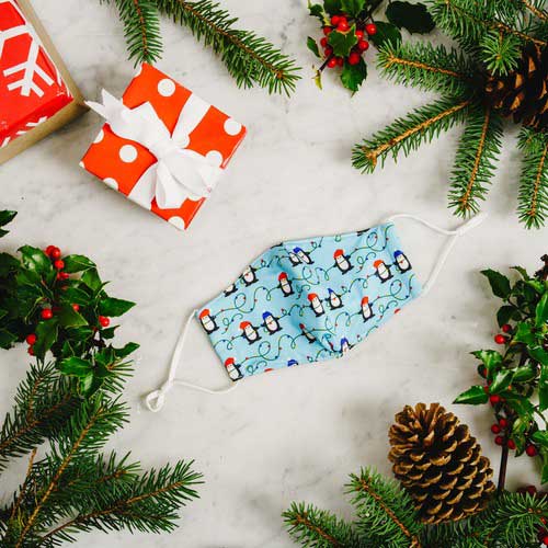 Penguins & Lights kid's mask with Penguins wearing caps stringing Christmas lights mask under tree