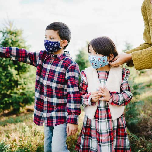 Snowflakes kid's face mask with snwoflakes on blue background children outdoors