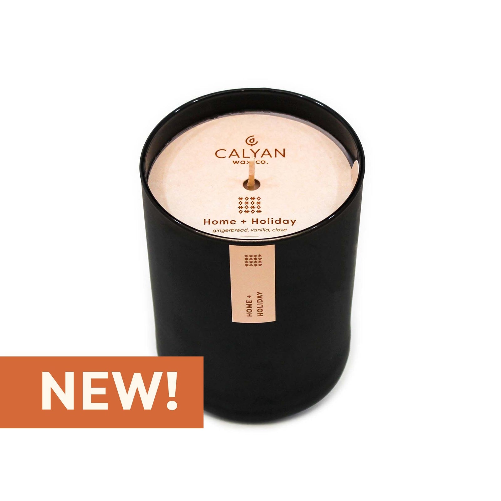 Black glass candle tumbler in Home + Holiday fragrance from Calyan Wax Co.