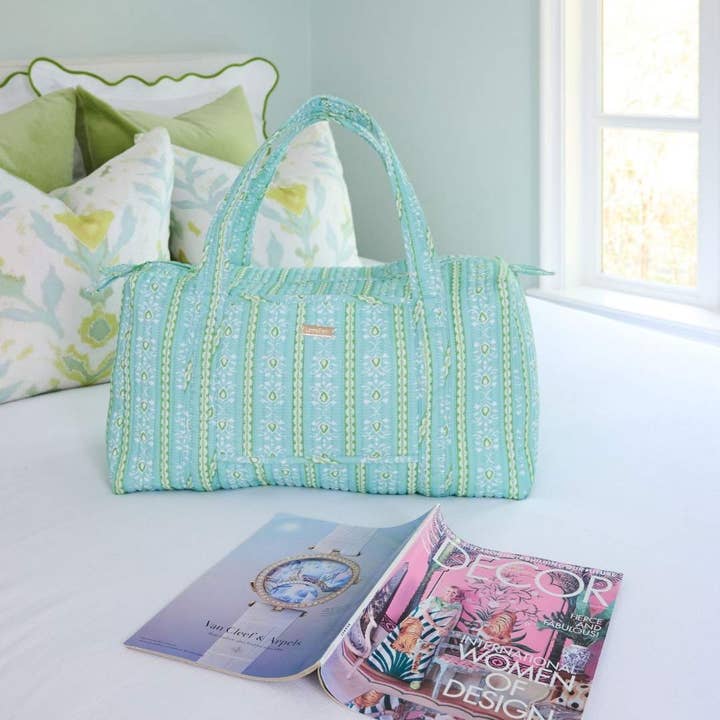 Rosemary Striped Blue Signature Duffel Bag in colorful blue, green, and white