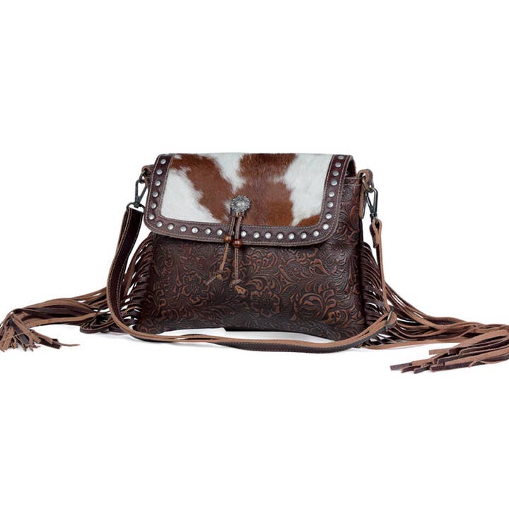 Carved Blossoms Leather & Hairon Bag has a 22" strap
