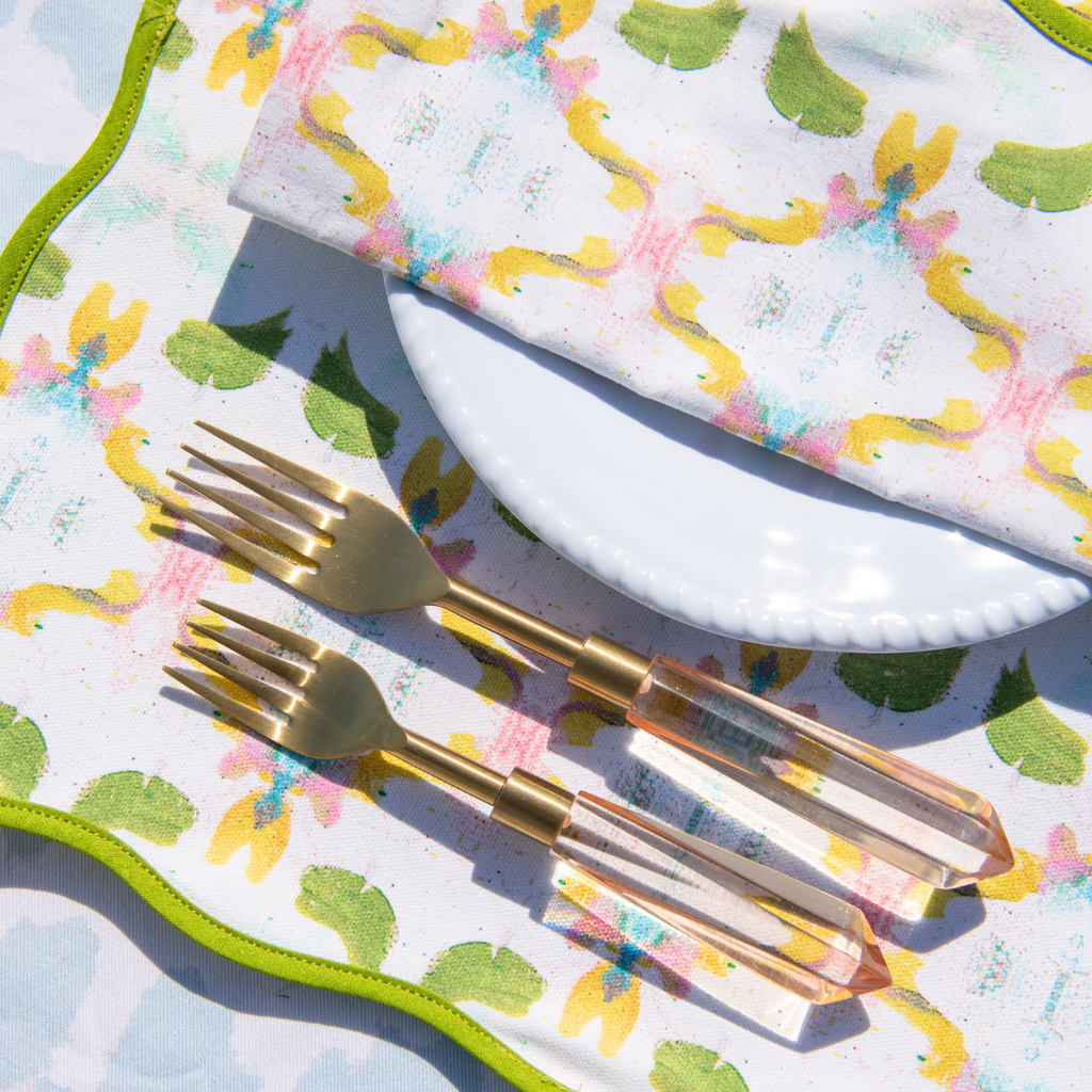 Dogwood Scalloped Placemats shwon with Blush Pink Acrylic Flatware.