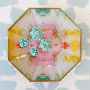 Jasmine Blue Gumball Earrings displayed on colorful cocktail plate
