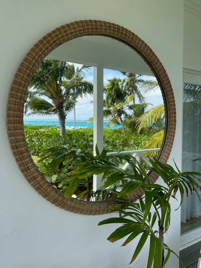 Dunmore Round Wicker Mirror by Amanda Lindroth provides a tropical breezy feel.