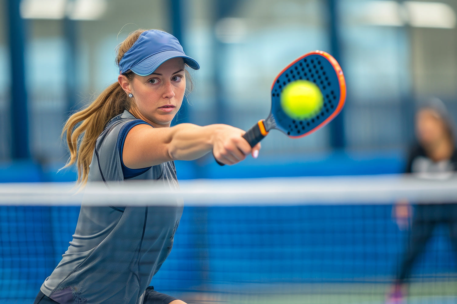 Pickleball player hitting ball