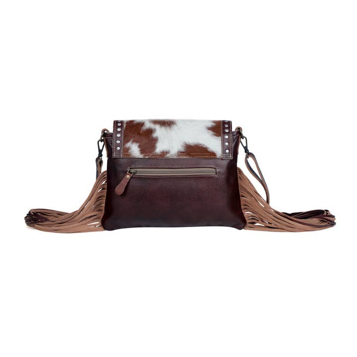 Carved Blossoms Leather & Hairon Bag has an exterior zippered pocket