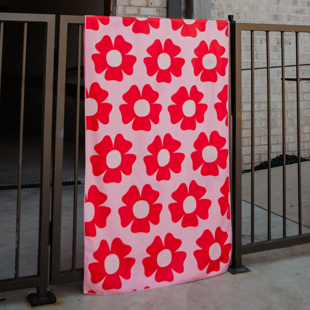 Flower Power Quick Dry Beach Towel red flowers on pink background on the other side