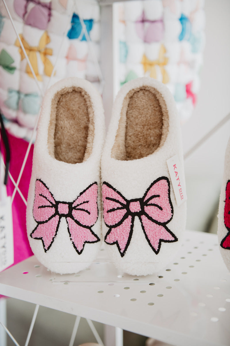 Light Pink Bow Fuzzy Slippers on display