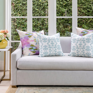Begonia Violet Throw Pillow in lifestyle sofa setting with complementary Chintz Mist patterns