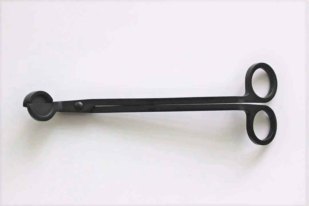 Black wick trimmer with angled cutting head from Calyan Wax Co. flat view