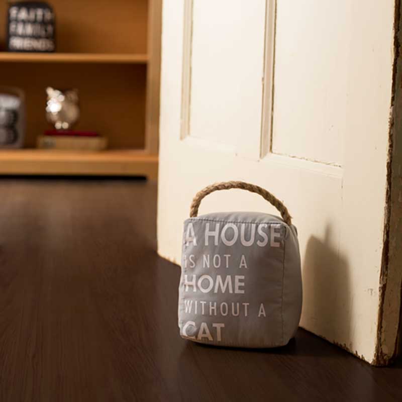 Cat Door Stopper with slogan printed on 5" tall door stopper lifestyle image