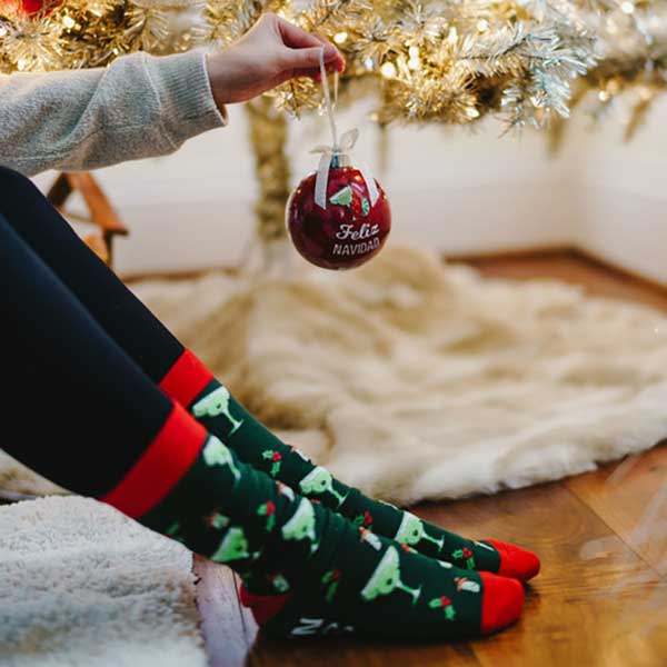 Feliz Navidad Christmas socks and ornament with margarita glasses on socks woman hanging ornament