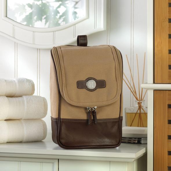 Hanging toiletry bag in light brown canvas with leather accents, front view