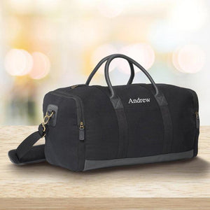 Black canvas duffle bag with black trim and embroidered name option