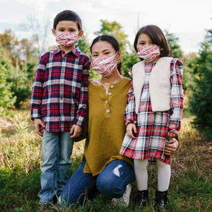 Holiday Paws Kid's Face Mask disposable with paw prints on red ribbon family wearing masks