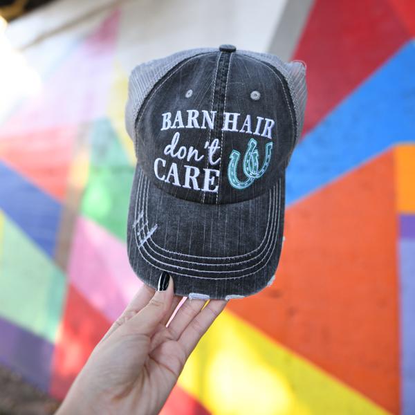 Barn Hair Don't Care embroidered trucker hat with mint horseshoes by Katydid, held by woman