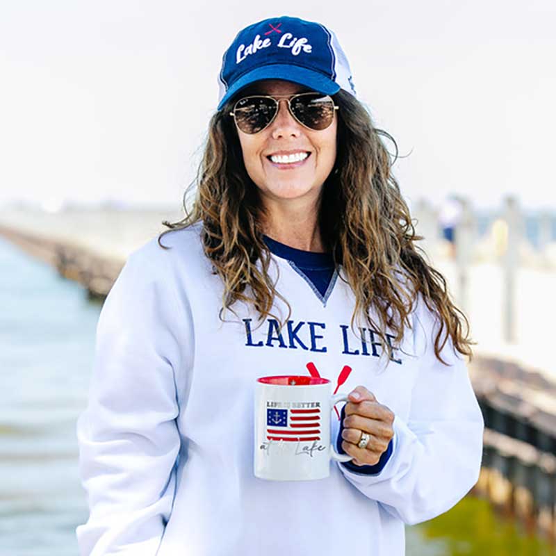 Life Is Better At The Lake mug held by woman in Lake Life shirt