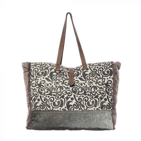 Floral print weekender bag of canvas, leather and hairon from Myra Bag front view