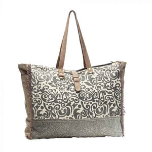 Floral print weekender bag of canvas, leather and hairon from Myra Bag