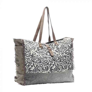 Floral print weekender bag of canvas, leather and hairon from Myra Bag packed