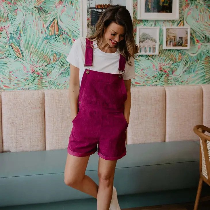 Raspberry Corduroy Overalls shown with model wearing white tee