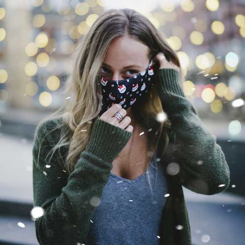 Santa Cat holiday adult face mask with smiling cats in caps woman wearing mask