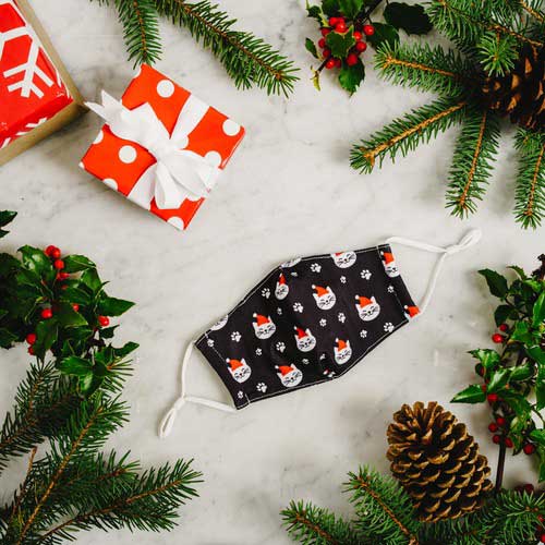 Santa Cat kid's face mask with cats in red caps and paw prints under Christmas tree