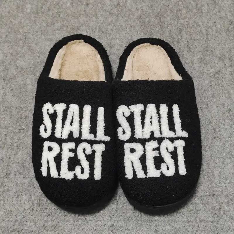 Stall Rest Slippers are black sherpa fleece with with lettering