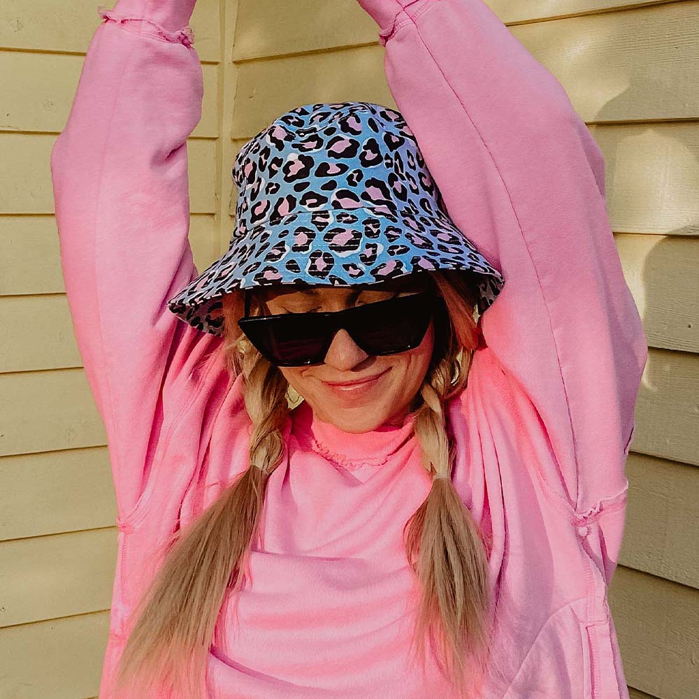 Blue Leopard Print Bucket Hat worn by model in pink shirt