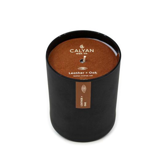 Black matte glass tumbler candle Leather + Oak fragrance from Calyan Wax Company