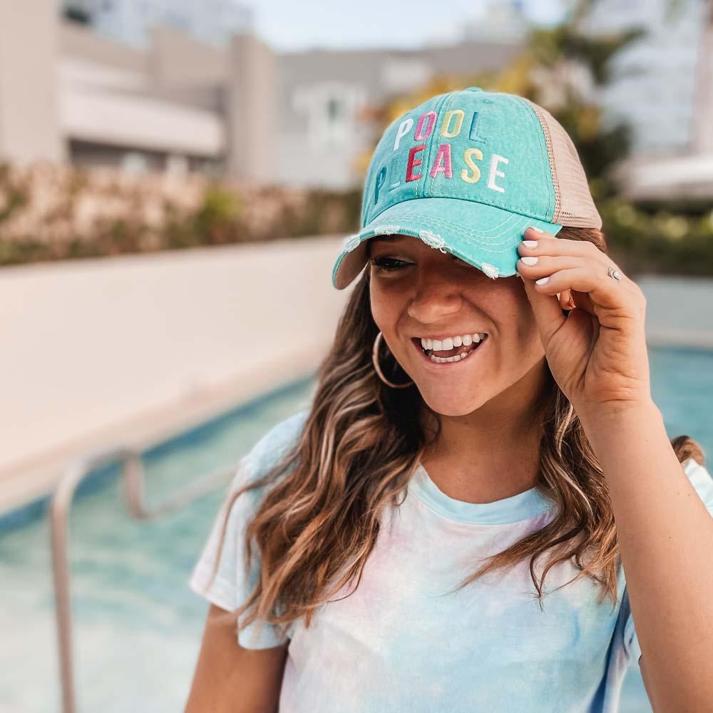Pool Please trucker hat from Katydid with model wearing teal color poolside