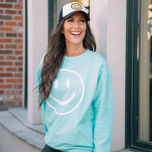 Smiley Face Corded Sweatshirt in aqua worn by model with smiley face cap