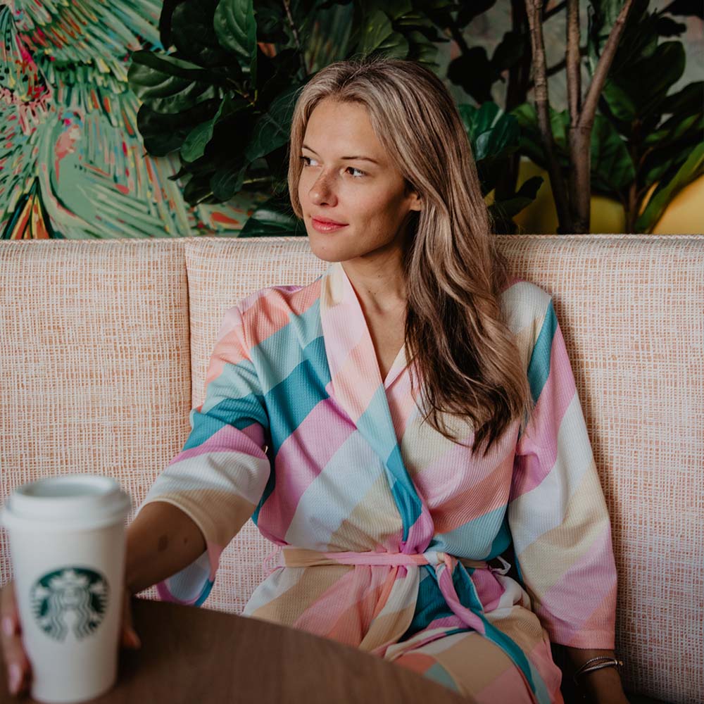 Striped Pastel Printed Bath Robe worn by model seated with coffee cup