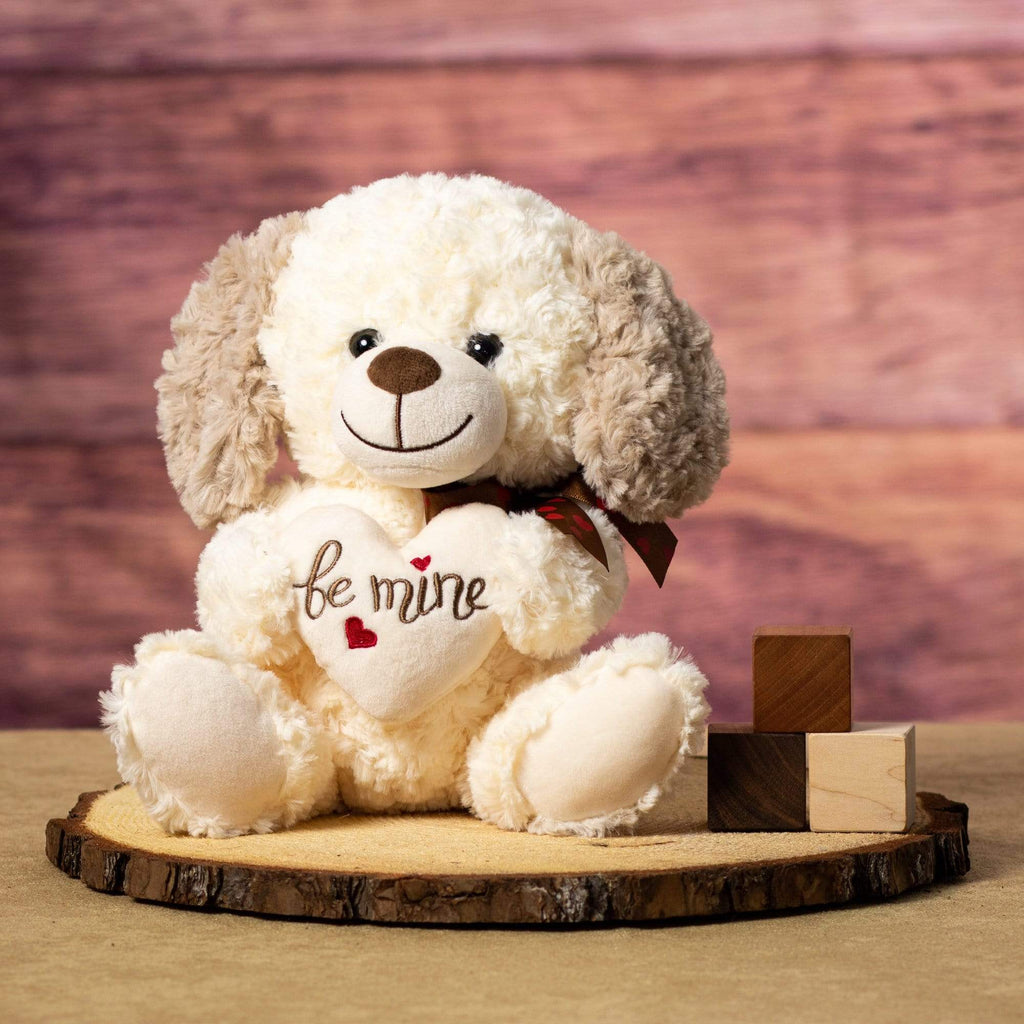 Plush Valentine Dog holding a cream-colored heart inscribed with "Be Mine"