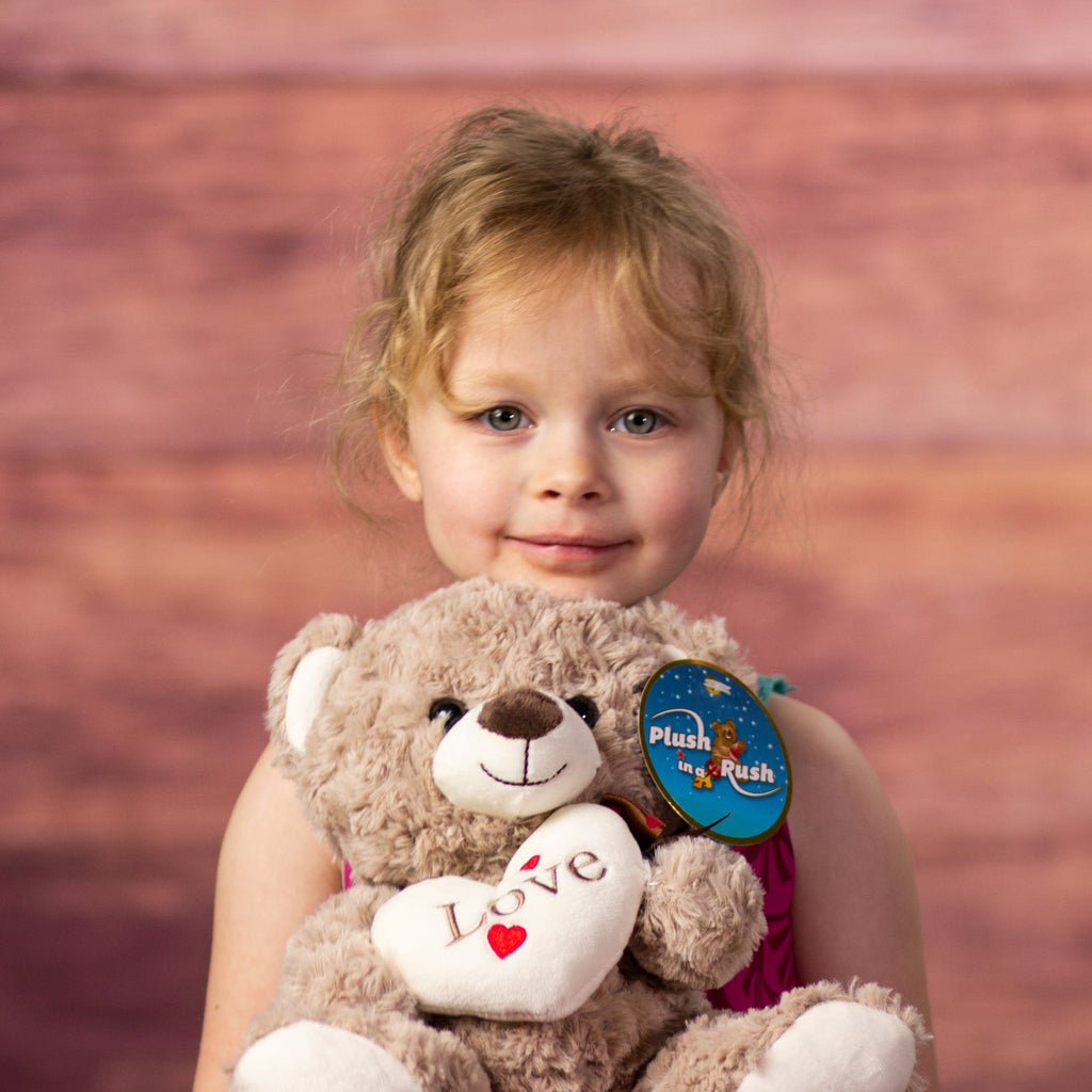 Plush Valentine Bear held by child