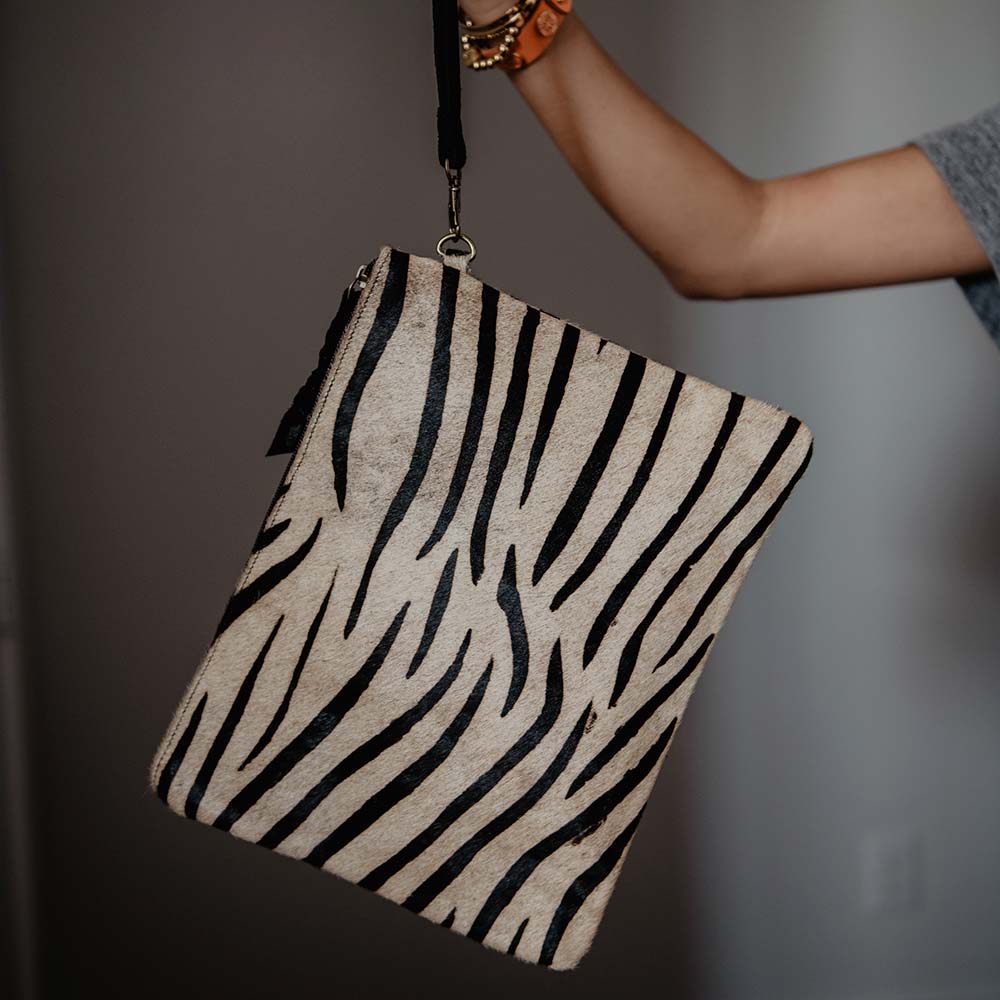 Grey & Black Zebra Hair On Leather Clutch woman holding by strap